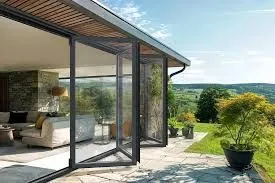 Black-framed bifold doors opening beside a covered terrace with countryside beyond